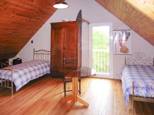 a bedroom with two beds and a dresser in a attic at Holiday Home in Piriac near Sandy Beach in Piriac-sur-Mer