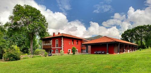 
a red brick building with a red roof at Hotel Rural Coviella in Coviella
