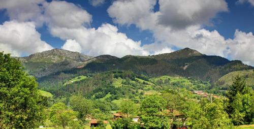 a view of a mountain range with trees and houses at Hotel Rural Coviella in Coviella