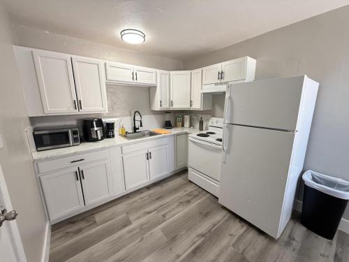 a kitchen with white cabinets and a white refrigerator at Downtown Apt 5 Min Walk to Downtown - Free Parking in Las Vegas