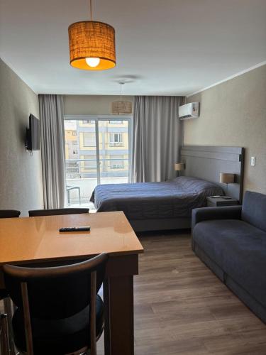 a hotel room with a bed and a couch at Departamento Casa de playa in Necochea