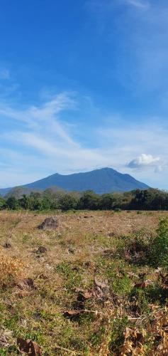 an open field with mountains in the background at Beach cabin ometepe in Altagracia