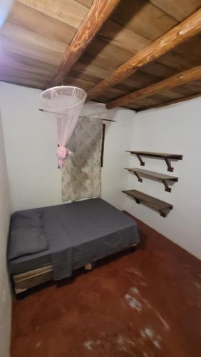 a room with a bed and a basketball hoop at Popoyo Surf House Guasacate in La Albina