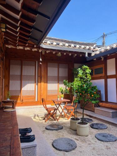 a patio with a table and chairs in a building at JoongRimJae - Hanok in Seoul