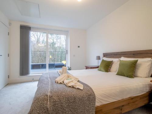 a bedroom with a large bed and a window at Fabulous Festival Park Home Private Parking Garden Pass the Keys in Glasgow