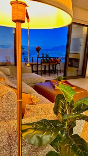 a lamp in a living room with a plant at Luxury, Ocean View, Pool, Jacuzzi, Valle de Guadalupe, Los Portales De Garcia, Splash, Encanto Restaurants, Surf Breaks in Primo Tapia, Rosarito in Rosarito
