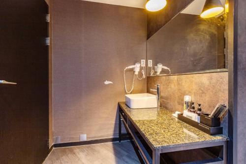 a bathroom with a sink and a mirror at DUBLIN Hotel in Busan