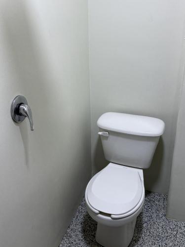 a bathroom with a white toilet in a stall at HOTEL ESTADIO S.A in Mexico City