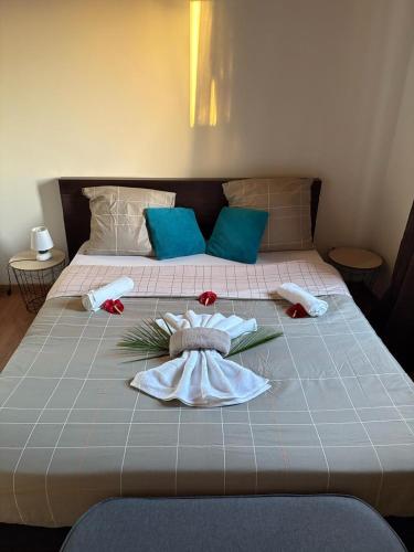 a bed with towels and flowers on top of it at Villa Mont Horizon in Saint-Pierre