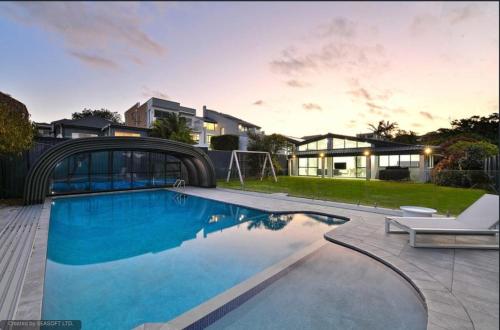 a swimming pool in the backyard of a house at Amazing Ocean Villa close to Natural Rock Pools in Sydney