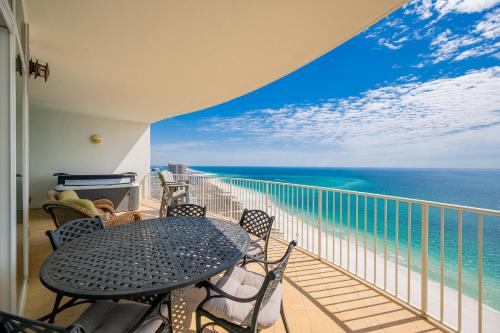 a balcony with a table and chairs and the ocean at Turquoise Place C2602 condo in Orange Beach