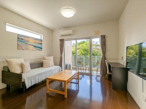 a living room with a couch and a table at Odysis Onna Resort Hotel in Onna