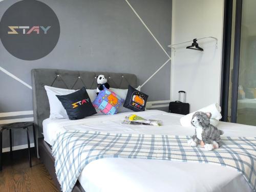 a bedroom with a bed with a stuffed animal on it at Almas 2Pax Cozy Serene Grey Puteri Harbour BySTAY in Iskandar Puteri
