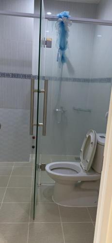 a bathroom with a toilet and a glass shower stall at Hữu Đặng in Chau Doc