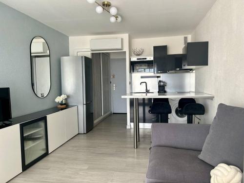 une cuisine et un salon avec un canapé et une table dans l'établissement Studio rénové face mer avec parking, au Cap d'Agde - FR-1-723-172, au Cap d'Agde