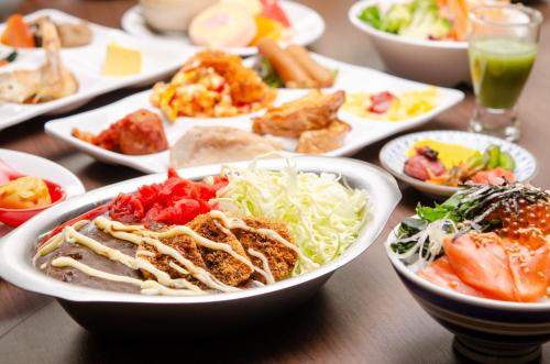 a table full of plates of food on a table at KKR Hotel Kanazawa in Kanazawa