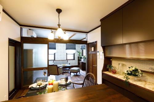 a kitchen and dining room with a fireplace at Rakumankan in Kyoto