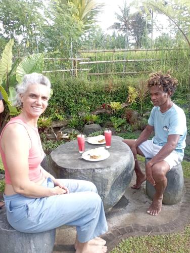 a man and a woman sitting around a table at One Bali Villa in Bangli