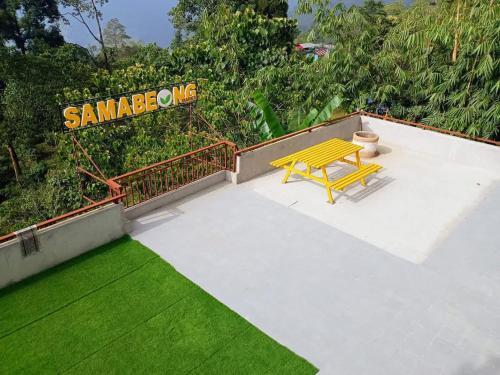 a yellow bench sitting on top of a roof at Samabeong Homestay Tindhurey in Lava