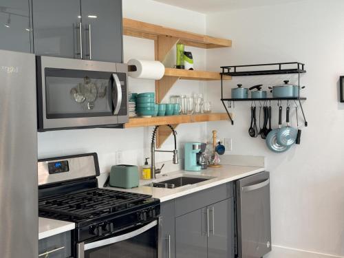 a kitchen with a stove and a sink at Chic, Cozy & Comfort Modern Room in Austin