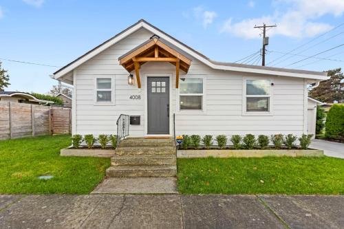 a white house with a door at Cozy Home 2br, 1ba with Portable AC - Pet Friendly in Tacoma