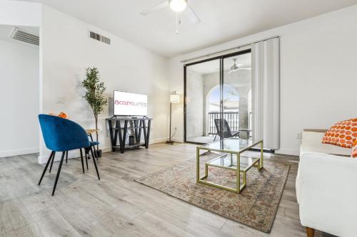 a living room with a couch and a table at CozySuites Glendale by the stadium with pool 31 in Glendale