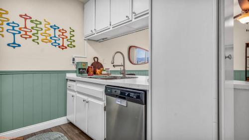 a kitchen with a sink and a dishwasher at Mid-Century Desert Getaway in Indio