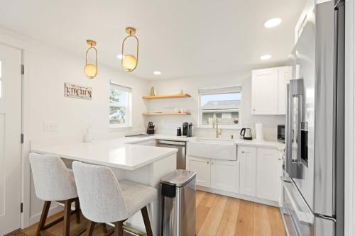 a kitchen with white cabinets and a white counter top at Cozy Home 2br, 1ba with Portable AC - Pet Friendly in Tacoma