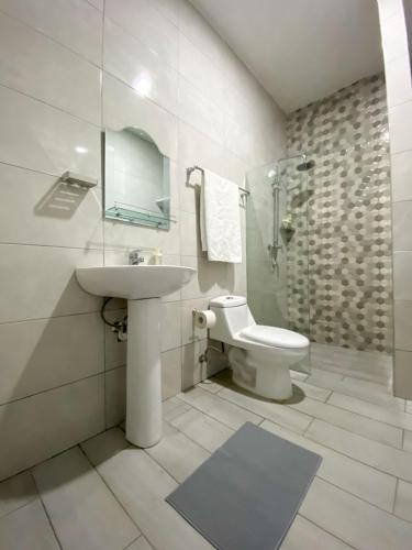 a white bathroom with a sink and a toilet at Colonial zone 3 bed 3 rooms balcony in Santo Domingo