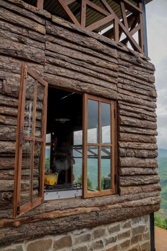 a window on the side of a log building at Monad Stopovers in Krola Dong (2)