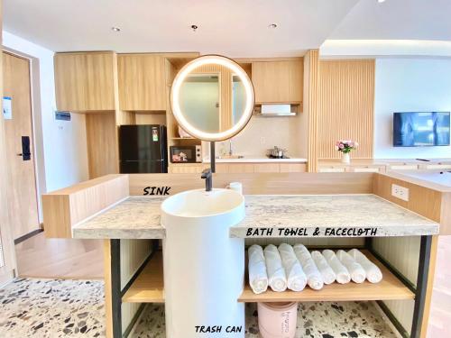 a bathroom with a sink and a mirror on a counter at Luxury SeaView Apartment in 5 star Resort, An Bàng - Hội An in Dien Ban