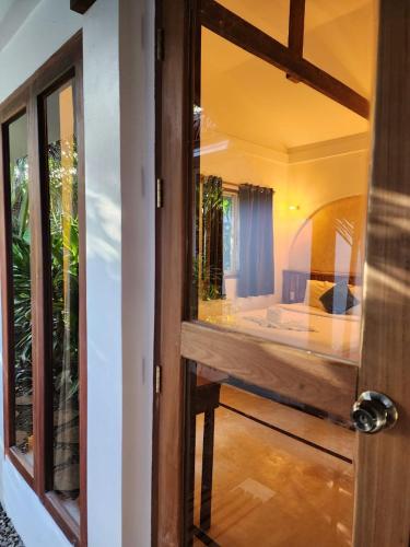 a door leading into a room with a bedroom at Prana Siargao Resort in General Luna