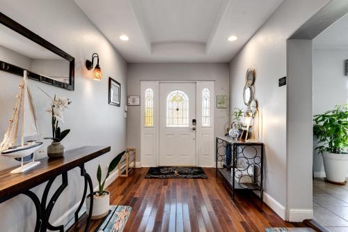 a home entry with a white door and wooden floors at South Florida Spacious Oasis 4BR Retreat with 2 King Beds, Amazing Pool, near Beaches in Deerfield Beach