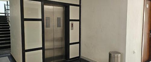a elevator in a building with a metal door at The Girvar Hotel, Barr in Beāwar