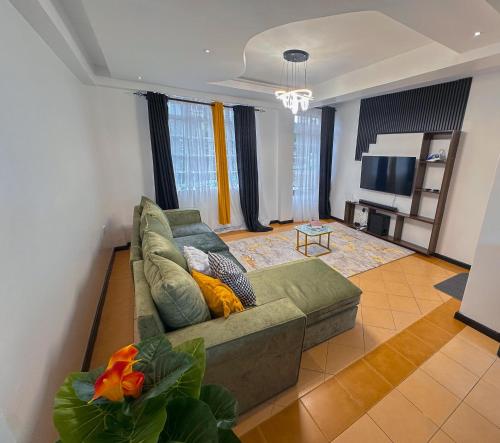 a living room with a couch and a television at Normad homes in Kisii