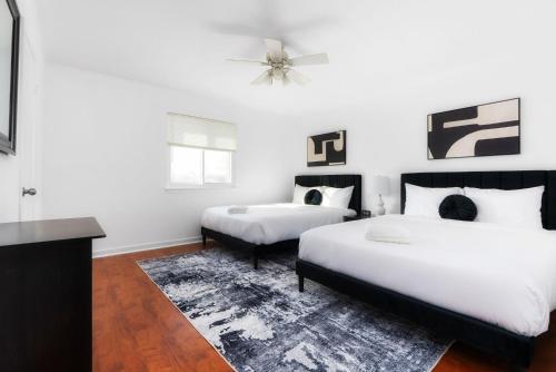 a bedroom with two beds and a rug at Pool HotTub FirePit BBQ Billiard PS4 Golf in Pflugerville