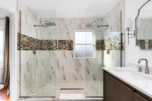a white bathroom with a shower and a sink at Pool HotTub FirePit BBQ Billiard PS4 Golf in Pflugerville