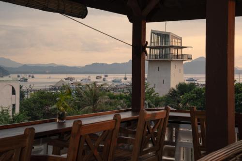 a view of a lighthouse from the porch of a building at Green Hill Boutique Hotel in Labuan Bajo