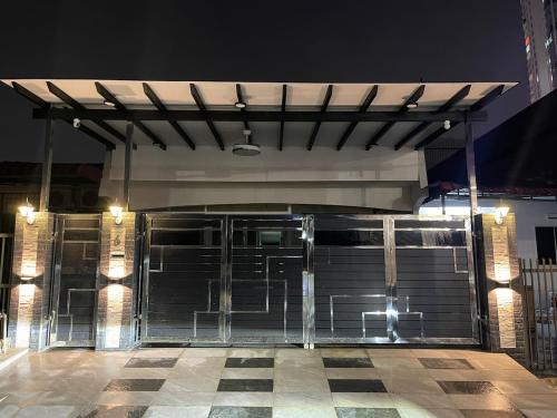a garage with a metal garage door at night at Cozy Room 2pax #1min walk to KSL #Bathroom in Johor Bahru