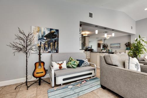 a living room with a guitar and a couch at South Florida Spacious Oasis 4BR Retreat with 2 King Beds, Amazing Pool, near Beaches in Deerfield Beach
