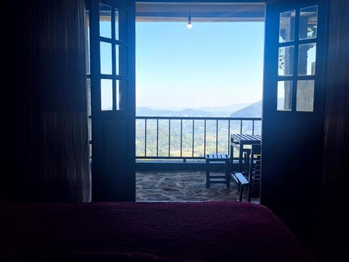 an open door to a balcony with a view at Aroma Holiday Home-Haputhale in Haputale