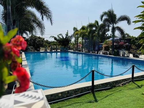 a large swimming pool with a chain fence around it at Ninh Chu 2 Hotel in Phan Rang