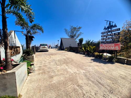a road with a car parked on the side at Aroma Holiday Home-Haputhale in Haputale