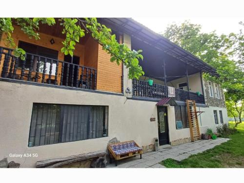 a house with a bench in front of it at Guest House Iaraji in Tʼianetʼi