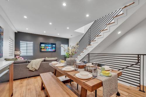 a living room with a table and a couch at Luxe Townhome Newly-Built in Sherman Oaks Community Hospital Heliport