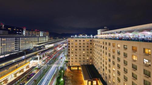 a view of a city at night with traffic at Miyako Hotel Kyoto Hachijo in Kyoto
