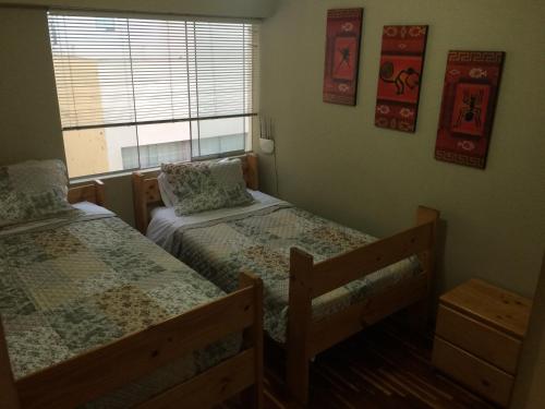 Postel nebo postele na pokoji v ubytování Cozy Condo in Miraflores