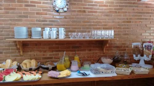 a table with a bunch of different types of food at Pousada Recanto das Águas in Lumiar