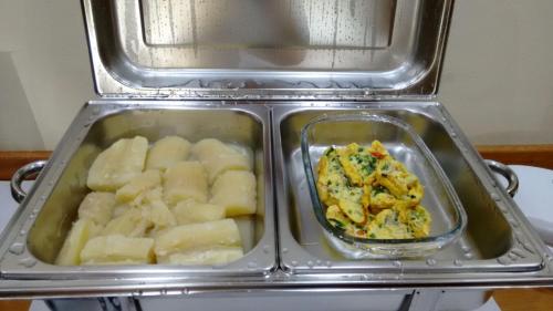 a container of food and a bowl of food at Pousada Recanto das Águas in Lumiar