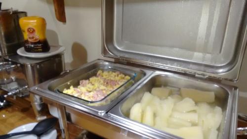 a tray of food in an open refrigerator at Pousada Recanto das Águas in Lumiar